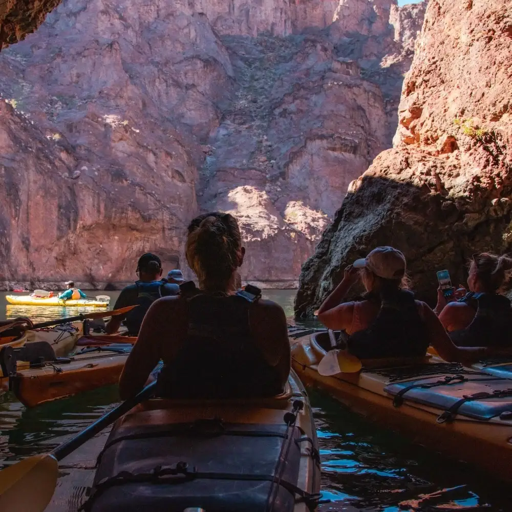 Kayakers paddling inside Emerald Cave