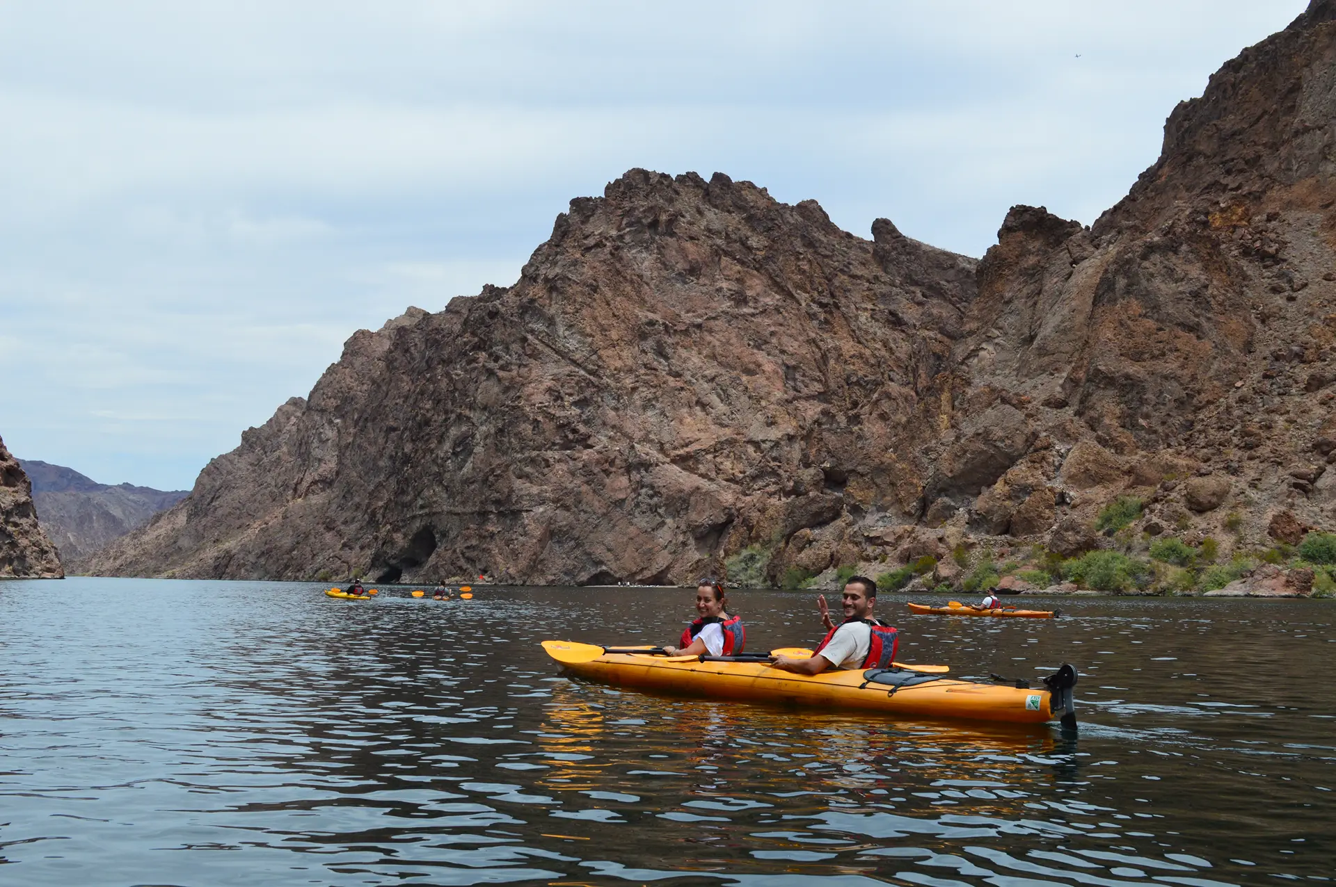 Couple smiling while paddling a tandem kayak through Black Canyon