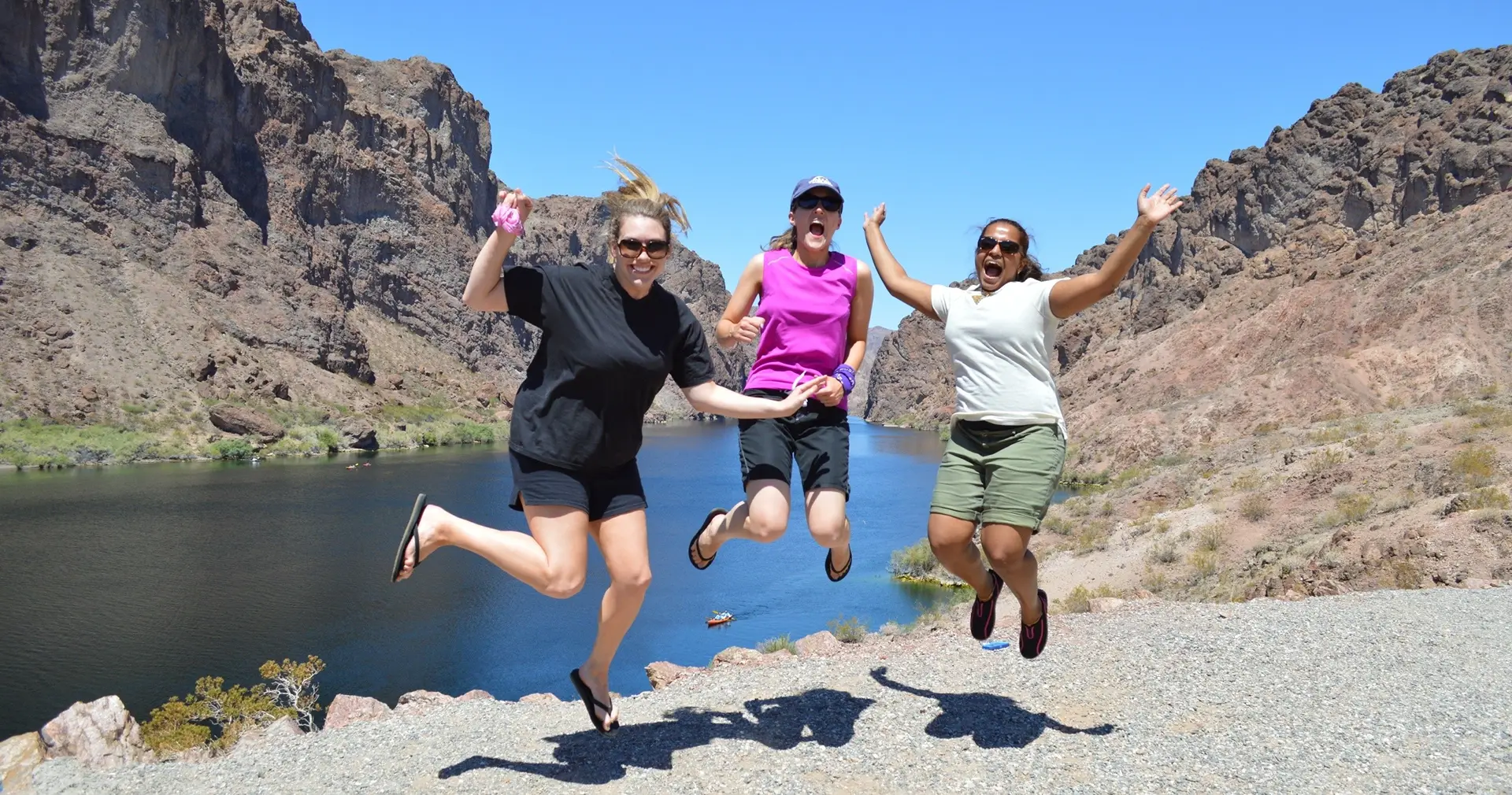 Friends jumping for joy above the Colorado River after the overlook hike